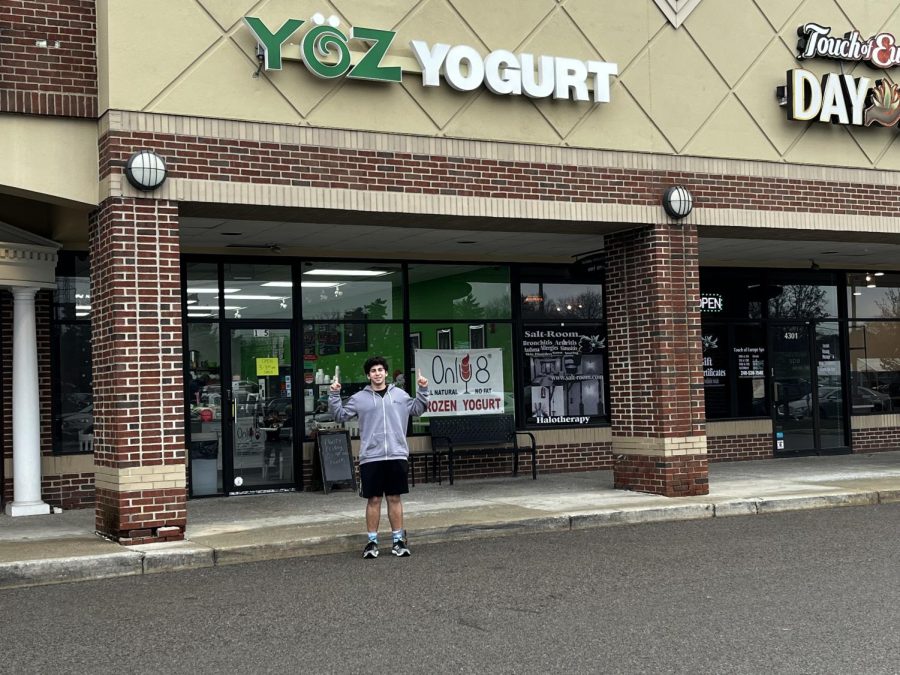 Benji Stern standing in front of Yoz Yogurt having eaten some amazing ice cream.