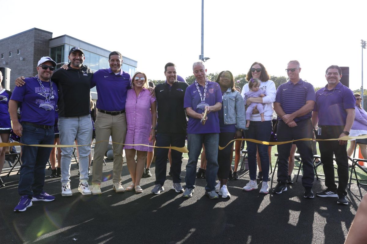 Past and current district administrators, school board members, and BHHS administration cuts the ribbon to unveil the new wellness center on September 12, 2025.
