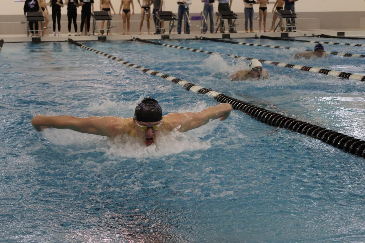 Junior Miles Marx flies high above the water during his 100 yard butterfly. 